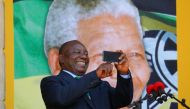 Cyril Ramaphosa use his phone during a rally to commemorate Nelson Mandela centenary year in Cape Town, February 11, 2018. Reuters / Mike Hutchings