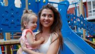 Olena Kudryashova and her daughter Maya smile before an interview with Reuters at a playgroung in Kiev, Ukraine August 12, 2019. Reuters/Valentyn Ogirenko
 