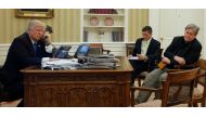 Donald Trump, seated at his desk with National Security Advisor Michael Flynn and senior advisor Steve Bannon speaks by phone with Australian PM Malcolm Turnbull, January 28, 2017. Reuters/Jonathan Ernst