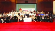 The participants posing for a group photo with Total officials.