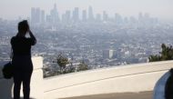  A woman takes photos of downtown Los Angeles from the Griffith Observatory on November 4, 2019 in Los Angeles, California. Mario Tama/Getty Images/AFP 