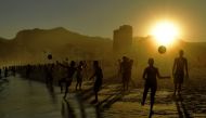 Beachgoers play with balls at Ipanema Beach in Rio de Janeiro on June 29, 2019. AFP / Carl De Souza