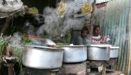 Women sit next to their cooking stoves at the sprawling Kibera slums in Kenya's capital Nairobi, June 8, 2009. Reuters/Noor Khamis