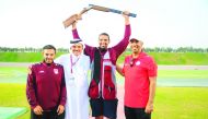 Mohamed Al Rumaihi (second right) celebrates with Qatar Shooting and Archery Association President Ali Mohamed Al Kuwari, on getting the Olympic quota yesterday.