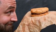 Casey Dean inspects a McDonald's burger bought in 1995 and kept in an Australian shed for years... AFP / William West 