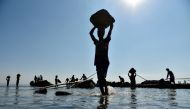 Labourers extract sand from the riverbed of the Beki River in the district of Barpeta of the northern Indian state of Assam on November 4, 2019. AFP / David Talukdar
 