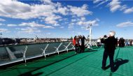 Women pose for a picture in front of Helsinki's cityscape, Finland, May 6, 2017. Reuters/Ints Kalnins