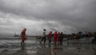 Hindu pilgrims walk by the dock after a ferry service to Sagar Island was suspended due to the approaching Cyclone Bulbul in Kakdwip in West Bengal state on November 9, 2019. Cyclone Bulbul, packing a maximum wind speed of 120 kilometres per hour (75 mile