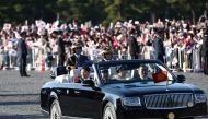 Japan’s Emperor Naruhito (L) and Empress Masako (R) wave during a royal parade in Tokyo on November 10, 2019. / AFP / Behrouz MEHRI