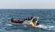 British rescuers helping some 20 migrants on a semi-rigid boat trying make their way from France across the English Channel on February 18, 2019. AFP / Societe Nationale de Sauvetage en Mer
