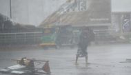 A pedestrian makes his way under heavy rain as cyclone Bulbul approaches the area in Khulna on November 10, 2019. AFP / Munir Uz Zaman 