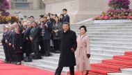 File photo of Chinese President Xi Jinping and his wife Peng Liyuan arrive to take part in a welcome ceremony of French President Emmanuel Macron at the Great Hall of the People in Beijing on November 6, 2019. / AFP / Ludovic MARIN 