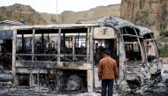 A man looks at the remains of buses burned during a protest after Bolivia's President Evo Morales announced on Sunday that he was resigning, in La Paz, Bolivia November 11, 2019. Reuters / Carlos Garcia Rawlins
 
