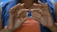 Venezuelan Ruth Perez, 35, shows a picture of her late brother Jesse in Caracas on Ocober 11, 2019. AFP