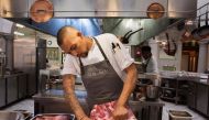 Germaine Esau, Chef de cuisine at the Myoga fine-dining restaurant, prepares a side of beef for smoking, often using Baleni salt in his culinary creations in Cape Town, on September 19, 2019. AFP / Rodger Bosch
 
