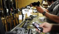 Customers look over the last two AR-15 style rifles for sale inside the Bullet Hole gun shop in Sarasota, Florida. (Reuters file photo) 