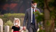 Attendees wearing protective masks walk at Delhi War Cemetery before Britain's Prince Charles' visit to the cemetery in New Delhi, India, November 13, 2019. (REUTERS/Altaf Hussain)