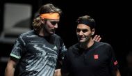 Greece's Stefanos Tsitsipas (L) and Switzerland's Roger Federer interact before the men's singles semi-final match on day seven of the ATP World Tour Finals tennis tournament at the O2 Arena in London on November 16, 2019. / AFP / Daniel LEAL-OLIVAS