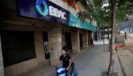 A man drives a motorbike past a closed bank office in Beirut, Lebanon November 15, 2019. Picture taken November 15, 2019. Reuters/Andres Martinez Casares