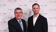 International Olympic Committee (IOC) President Thomas Bach (L) and Airbnb co-founder Joe Gebbia shake hands at an event in London to announce Airbnb as a leading partner of the Olympics on November 19, 2019. AFP / Daniel Leal-Olivas 