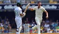 Australia's paceman Josh Hazlewood (R) celebrates his wicket of Pakistan's Babar Azam (L) on day one of the first Test cricket match between Pakistan and Australia at the Gabba in Brisbane on November 21, 2019. - / AFP / AFP / Saeed KHAN