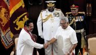 Sri Lanka's President Gotabaya Rajapaksa and his brother and former leader Mahinda Rajapaksa, who was appointed as the new Prime Minister, shake hands during the swearing in ceremony in Colombo, Sri Lanka November 21, 2019. REUTERS/Dinuka Liyanawatte