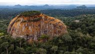 A large rock juts out from the tropical rainforest in the central African country of Gabon, August 23, 2012. (Josh Ponte Handout via Thomson Reuters Foundation) 