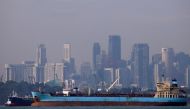 Oil tankers pass the skyline of Singapore, June 8, 2016. Reuters / Edgar Su