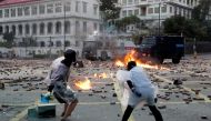 Anti-government protesters throw molotov cocktails towards police vehicles during clashes, outside Hong Kong Polytechnic University in Hong Kong, November 17, 2019. Reuters/Tyrone Siu