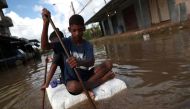Kids row on a styrofoam block through a flooded street during heavy rains in the Guaratiba neighborhood in Rio de Janeiro, Brazil April 10, 2019. Reuters/Ricardo Moraes