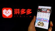 FILE PHOTO: The logo of Chinese online group discounter Pinduoduo is seen next to its mobile phone app in this illustration picture taken July 17, 2018. REUTERS/Florence Lo/File Photo