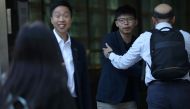 Winning candidate Kelvin Lam and activist Joshua Wong greet people and thank them for their support, outside South Horizons Station, in Hong Kong, China, November 25, 2019, the morning after Lam won in district council elections. REUTERS/Leah Millis