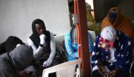 Migrants from Cameroon gather as they protect themselves from the cold inside the Juventud 2000 shelter in Tijuana, Mexico March 14, 2018. Reuters/Edgard Garrido
