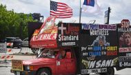 A man drives a pickup covered in billboards through downtown in the first day of the Republican National Convention on July 18, 2016, in Cleveland, Ohio. AFP / Getty Images