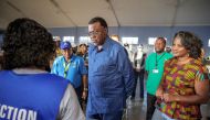 Namibia incumbent President and Namibia ruling party South West Africa People's Organization (SWAPO) presidential candidate Hage Geingob (C) goes through voting procedures on November 27, 2019 in Windhoek, Namibia. / AFP / GIANLUIGI GUERCIA