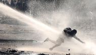A demonstrator is sprayed by a water cannon during a protest against Chile's government in Santiago, Chile, November 26, 2019. REUTERS/Ivan Alvarado
