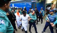 Police escort detainees (C) accused of allegedly plotting the Holey Artisan Bakery cafe attack, carried out by Islamist militants, to a courtroom for their trial in Dhaka on November 27, 2019. AFP / Munir UZ ZAMAN