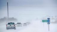 Motorists navigate an ice and snow-covered road on November 27, 2019 in Mason City, Iowa. Scott Olson/Getty Images/AFP