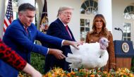 U.S. President Donald Trump pardons one of the 72nd National Thanksgiving Turkeys as Wellie Jackson, who raised the turkey, holds it as first lady Melania Trump looks on during turkey pardoning ceremonies in the Rose Garden of the White House, November 26