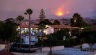 The Cave fire burns a hillside above houses in Santa Barbara, California on November 26, 2019. The wind-driven brush fire that started late on November 25, 2019 in Los Padres National Forest near Highway 154 in Santa Barbara County moved quickly downhill,