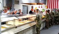 US President Donald Trump serves U.S. troops food at a Thanksgiving dinner event during a surprise visit at Bagram Air Base in Afghanistan, November 28, 2019. Reuters/Tom Brenner
 