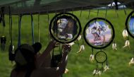 A woman organizes indigenous items after a Sunrise Ceremony during a 