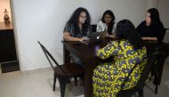 In this photograph taken on October 26, 2019, Vandita Morarka, 25, interacts with her colleagues as they sit around rented furnitures in Mumbai. AFP / PUNIT PARANJPE 