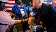 Joe Biden greets audience members during a stop on his 