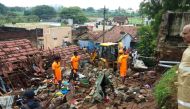 Rescue workers clear debris from a collapsed home in Mettupalayam, some 50 kilometres (30 miles) north of Coimbatore, on December 2, 2019. At least 17 people from four families in India were buried alive as they were sleeping on December 2 when heavy rain