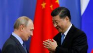 FILE PHOTO: Chinese President Xi Jinping and Russian President Vladimir Putin attend the ceremony of presenting Xi Jinping with a degree from the St Petersburg State University at the St Petersburg International Economic Forum in St. Petersburg, Russia, J