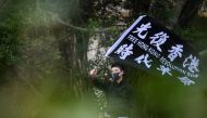A man waves a flag that reads 