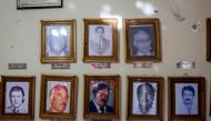 View of the bullet impacts in photographs of former municipal presidents with bullet impacts inside the municipal presidency in Villa Union, Coahuila state, Mexico, on December 2, 2019. AFP / Julio Cesar Aguilar
 