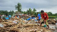 Residents gather debris from their destroyed houses after typhoon Kammuri hit the city of Sorsogon, south of of Manila on December 3, 2019. Typhoon Kammuri killed at least two people in the Philippines on December 3 as it tore roofs off houses and forced 