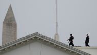 Uniformed US Secret Service Agents stand along the rooftop of the White House in Washington, US, December 2, 2019. Reuters/Tom Brenner